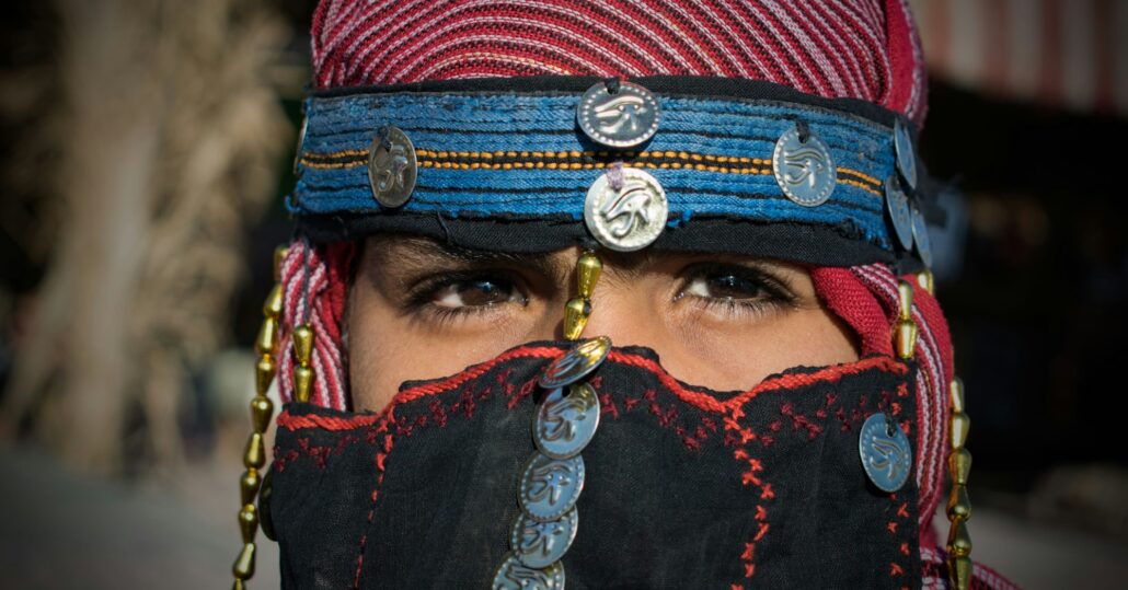 Closeup of a child in a veil with sewed coins
