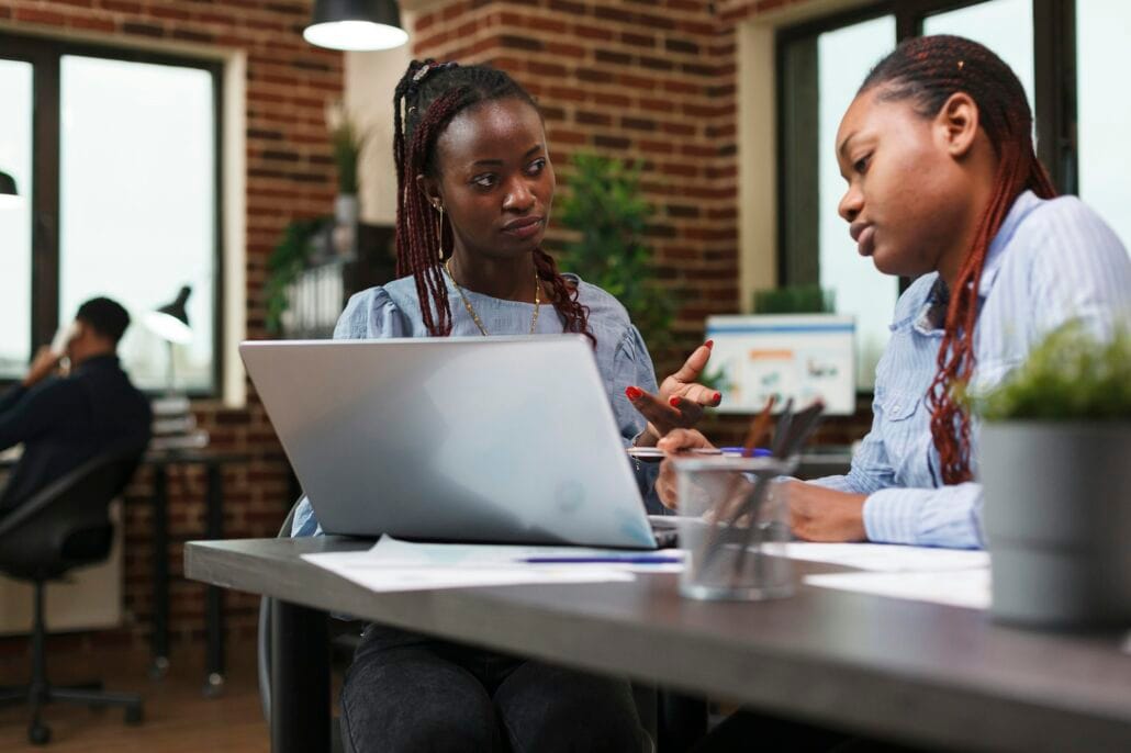 Research and development company office employees reviewing financial report