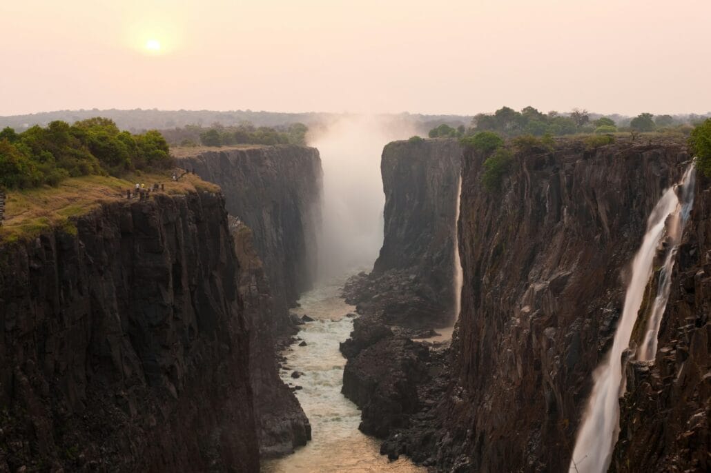 Victoria Falls, huge waterfalls of the Zambezi river flowing over sheer cliffs.