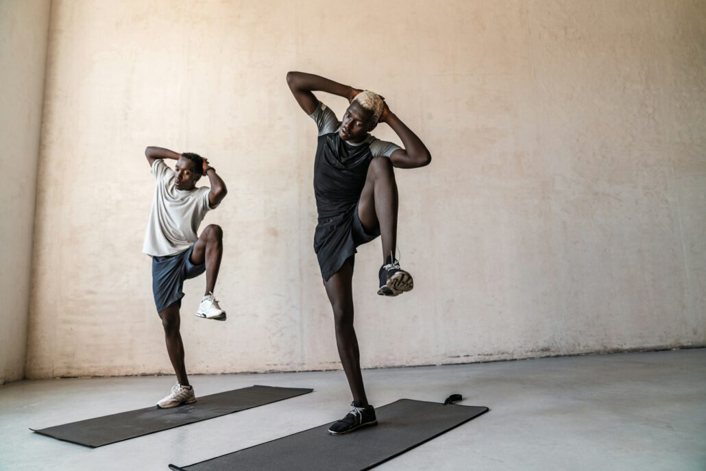 Two young handsome african american men doing workout indoors